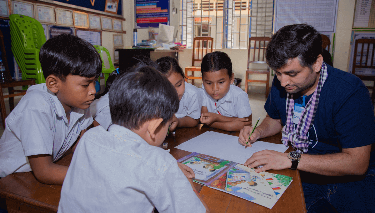 An Atlassian employee with Room to Read students