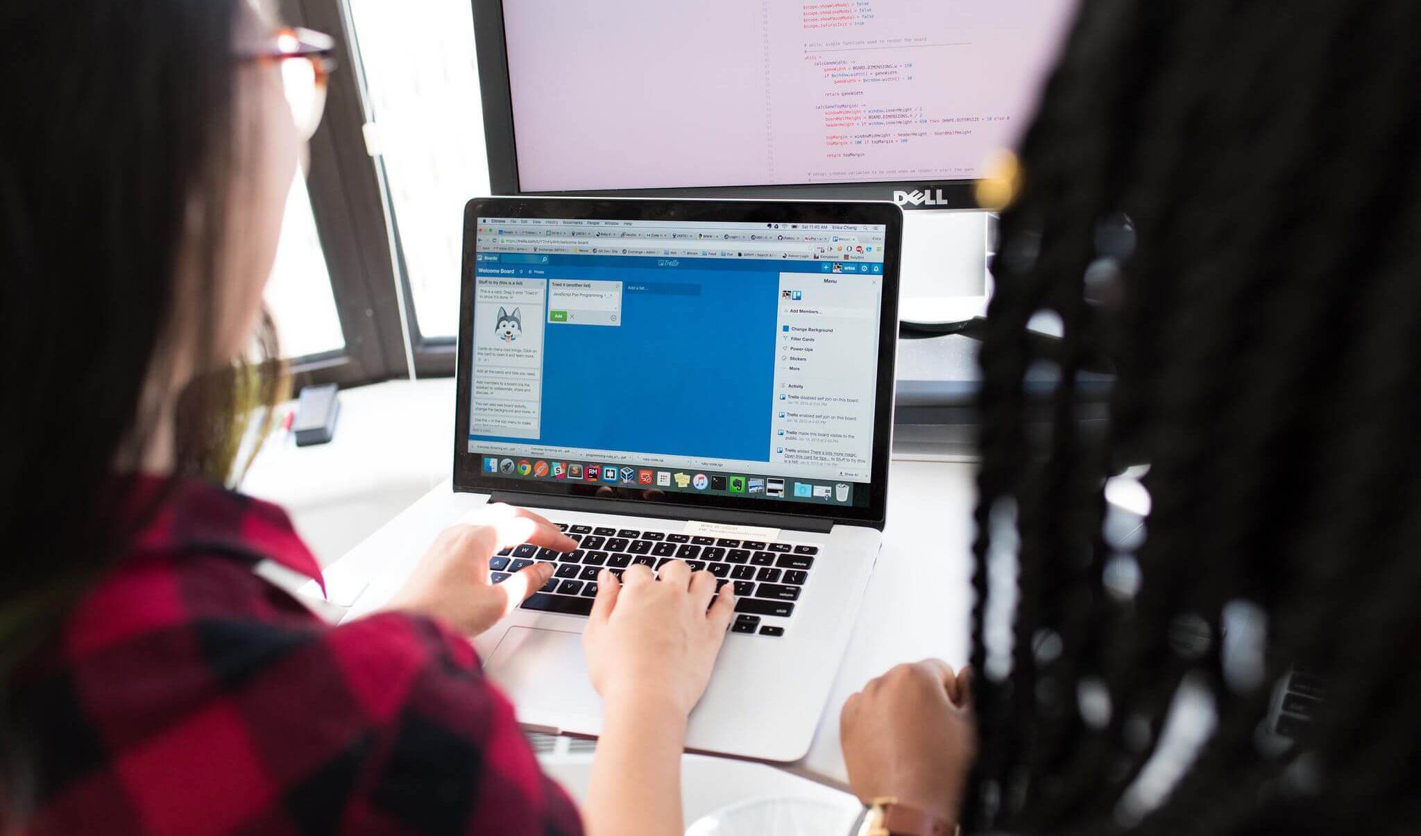 Two women collaborating on a Trello board